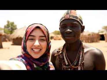 Young muslim tourist lady kisses african tribal man